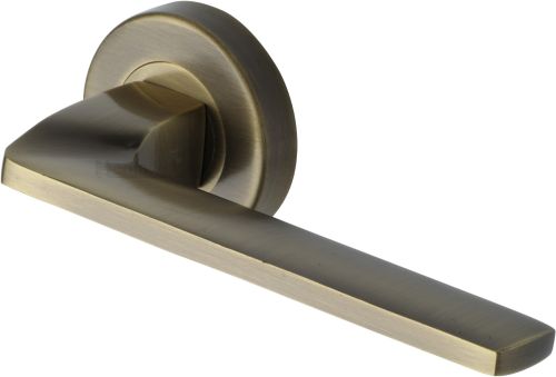 Click Here To Enlarge This Photo Of V3790-AT Heritage Brass Door Handle Lever Latch on Round Rose Metro Angled Design Antique Brass finish